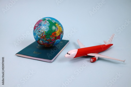 Traveling Around The World. Globe On Passport And Airplane Over Blue Background. 
