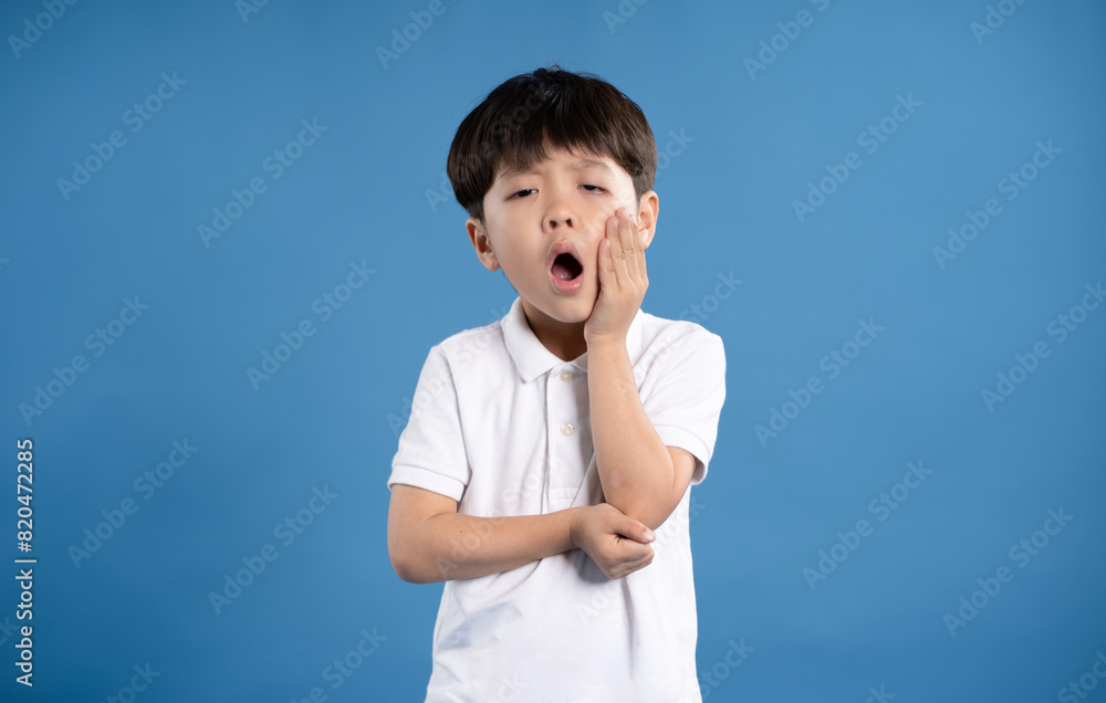 Portrait of asian boy posing on blue background Portrait of asian boy posing on blue background