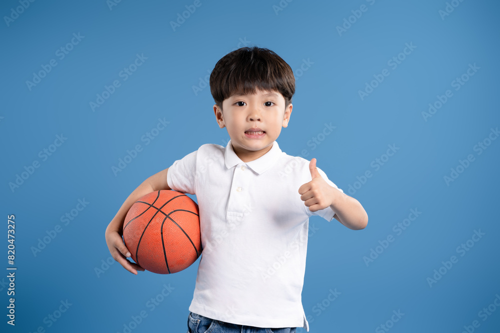 Portrait of boy in tank top playing basketball and Portrait of boy in tank top playing basketball and