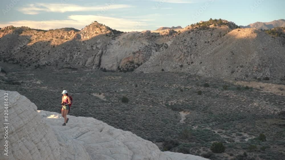 Young Woman on Hiking, Walking Alone on Top of Sandstone Hill at Sunset, Slow Motion Young Woman on Hiking, Walking Alone on Top of Sandstone Hill at Sunset, Slow Motion