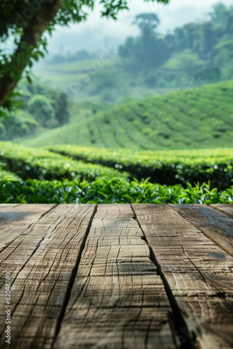 A wooden desk top with blurred background of tea plantation. Good for background 