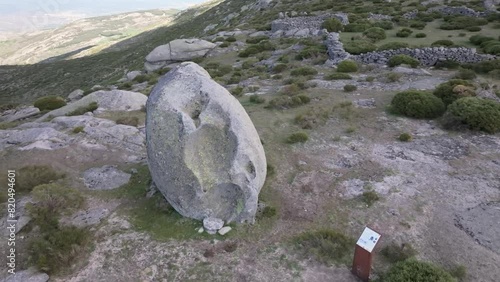 Orbital flight with a drone visualizing a sacred stone used to ask for and make offerings for having bowls in them used by the Celtiberian peoples. It is in an impressive viewing environment Avila photo