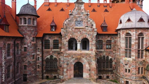 Iconic Cesvaines palace exterior with red rooftop, aerial ascend view photo