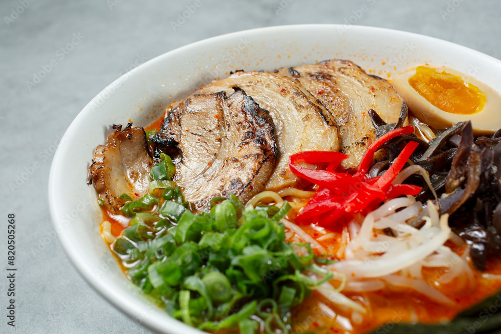 A closeup view of a bowl of spicy tonkatsu ramen. A closeup view of a bowl of spicy tonkatsu ramen.