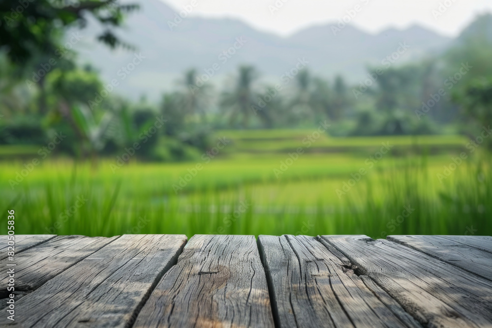A wooden desk top with blurred background of paddy field. Good for background A wooden desk top with blurred background of paddy field. Good for background