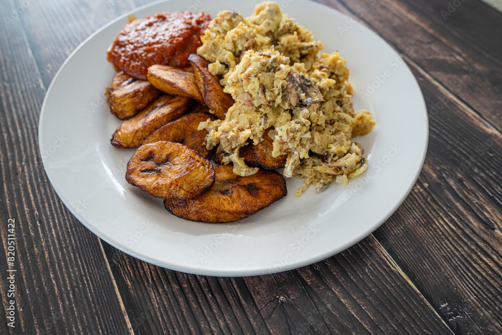Plantain and Eggs with pepper tomato sauce ready to eat Plantain and Eggs with pepper tomato sauce ready to eat