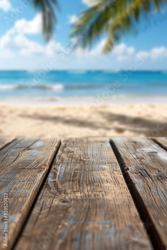 A wooden desk top with blurred background of beach. Good for background 