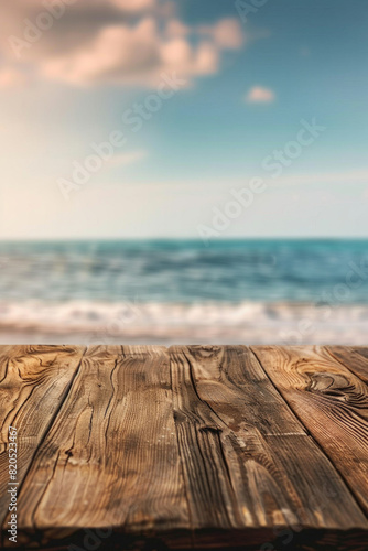 A wooden desk top with blurred background of beach. Good for background  © grey