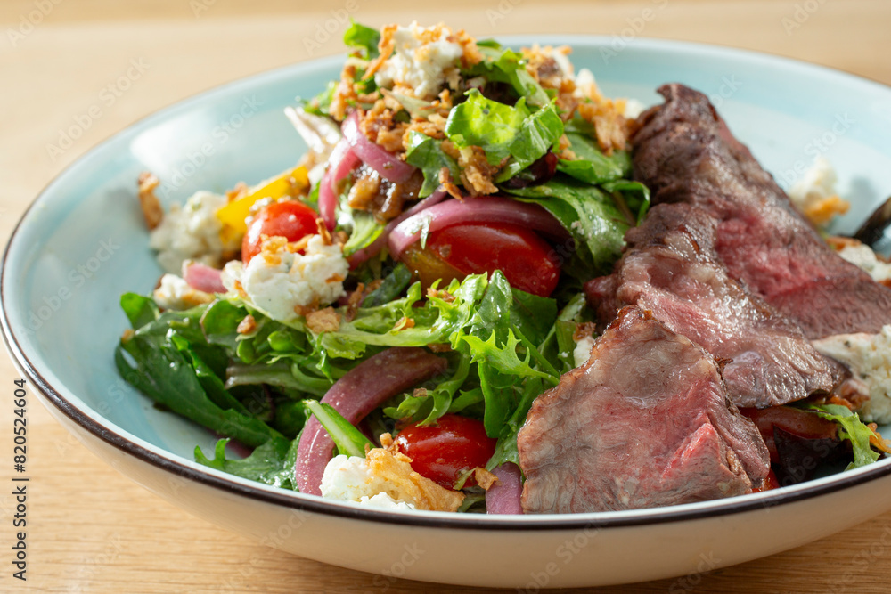 A closeup view of a steakhouse salad. A closeup view of a steakhouse salad.