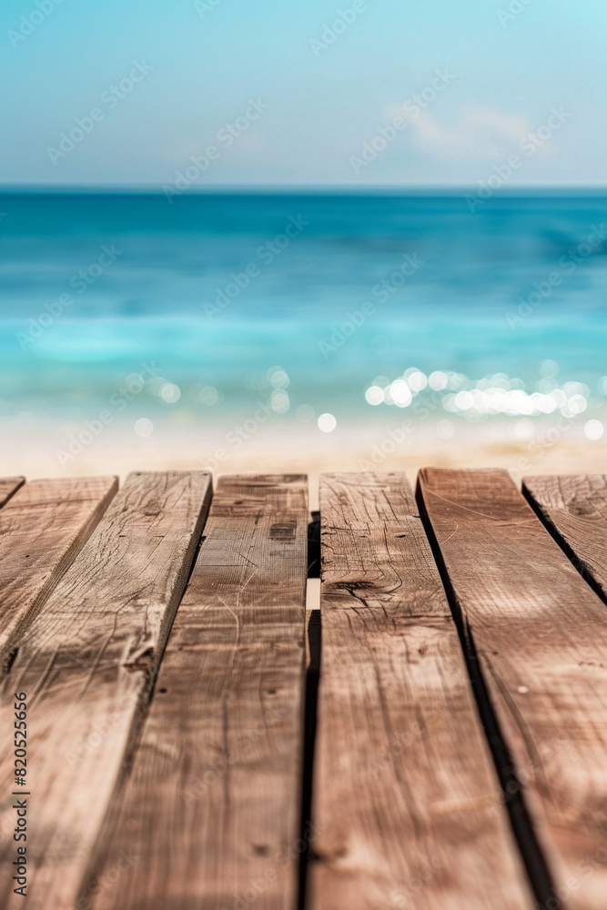 A wooden desk top with blurred background of beach. Good for background 