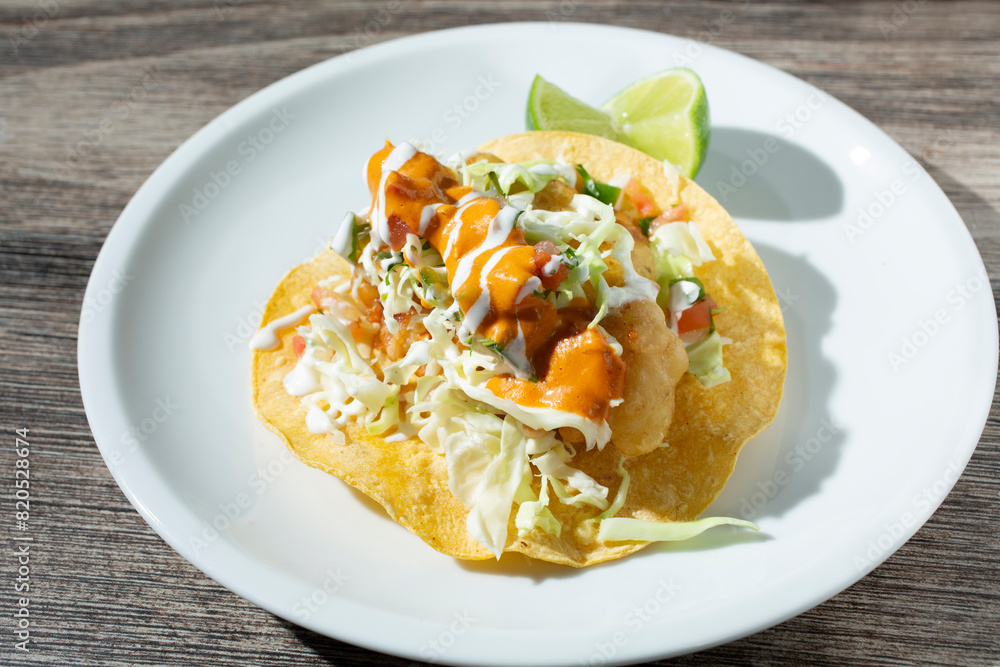 A view of a fish taco. A view of a fish taco.