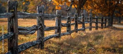 A rustic fence made of old wooden logs on the plot border. Generative AI