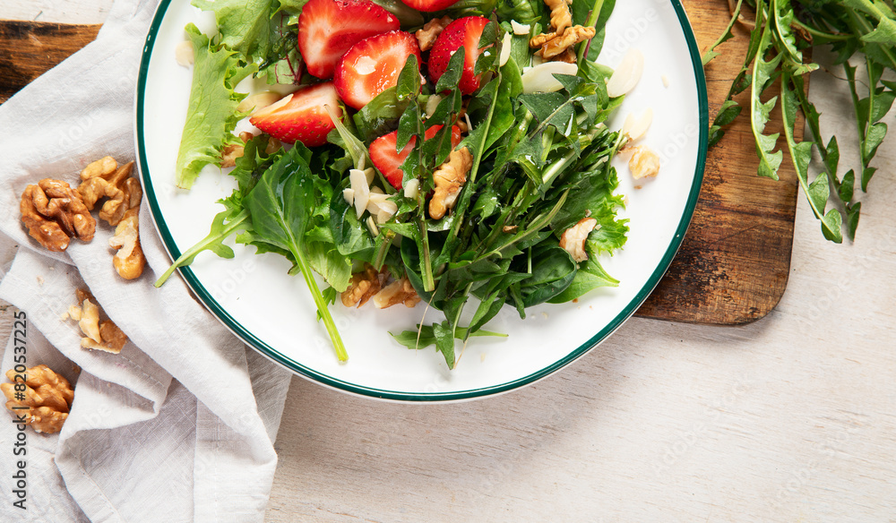 Fresh dandelion salad on light background. Edible plant and nectariferous. Fresh dandelion salad on light background. Edible plant and nectariferous.