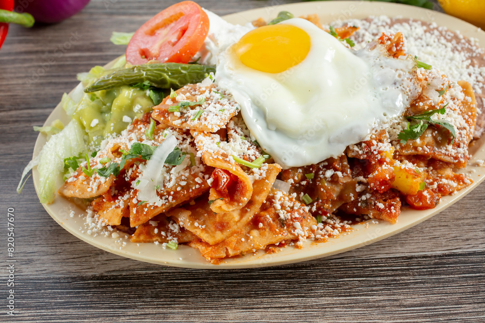 A view of a plate of chilaquiles. A view of a plate of chilaquiles.