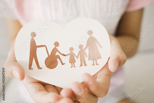 Hands holding diversity family in heart shape, happy carer and volunteer, disable nursing home, rehabilitation and health insurance concept photo
