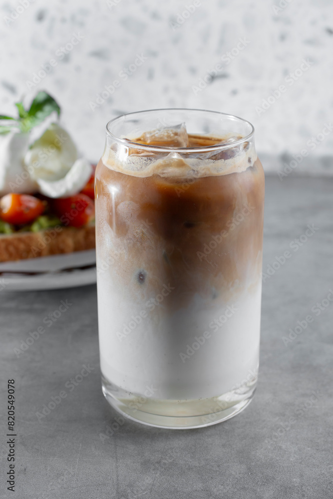 A view of a French vanilla coffee beverage in a can shaped glass. A view of a French vanilla coffee beverage in a can shaped glass.