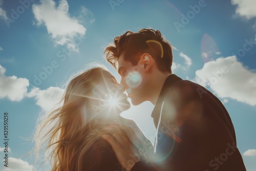 young couple kissing close up  sunny sky in the background for International kissing day July 6