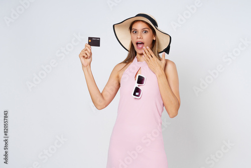 Excited Asian woman holding credit card on isolated on white background.
