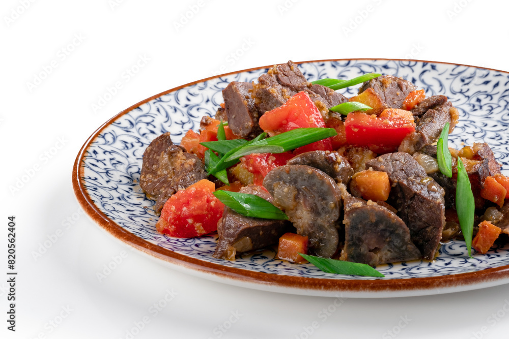 Fragrant roast of offal, lamb or beef meat with tomatoes and onions in a plate, isolated on white. A Central Asian dish made from the heart or lung of mutton, close up Fragrant roast of offal, lamb or beef meat with tomatoes and onions in a plate, isolated on white. A Central Asian dish made from the heart or lung of mutton, close up