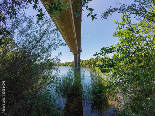 Underneath a bike trail bridge over a river  © Cam