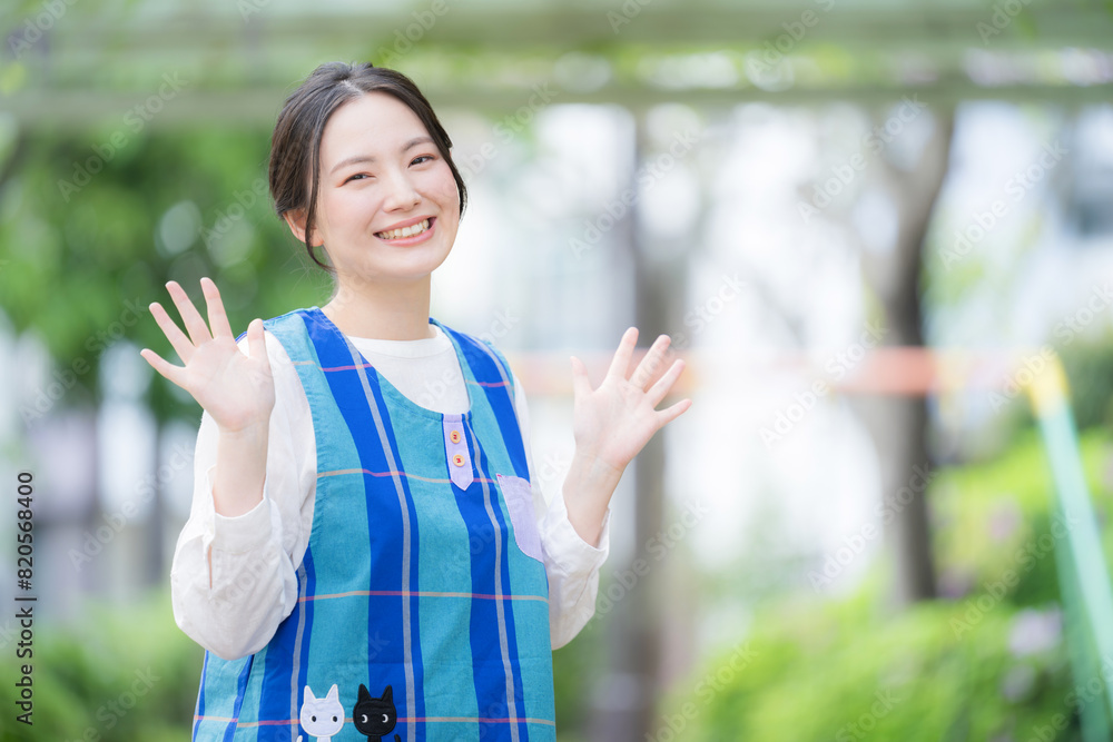 Childcare worker waving in the yard Good morning or good-bye image of the teacher, looking at the camera for a new job or employment opportunity. Childcare worker waving in the yard Good morning or good-bye image of the teacher, looking at the camera for a new job or employment opportunity.