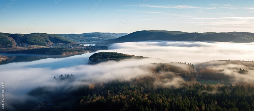 view from above of a morning mountain landscape with a lake dam and heavy view from above of a morning mountain landscape with a lake dam and heavy