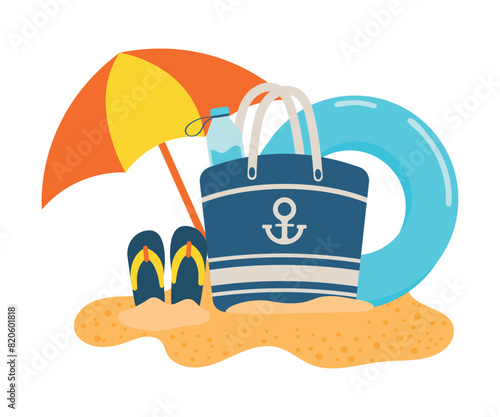 Beach bag on the sand with elements of relaxation on the sea, ocean. Swimming ring and a flip flop