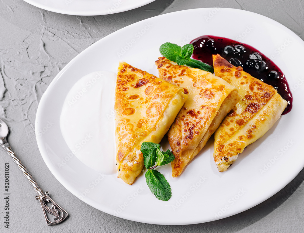 Gourmet breakfast with crepes, syrup top view Gourmet breakfast with crepes, syrup top view