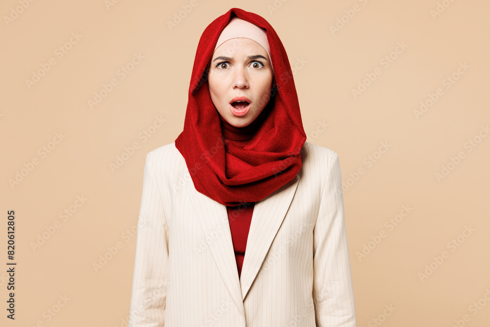 Young shocked surprised Arabian Asian Muslim woman wear red abaya hijab ...