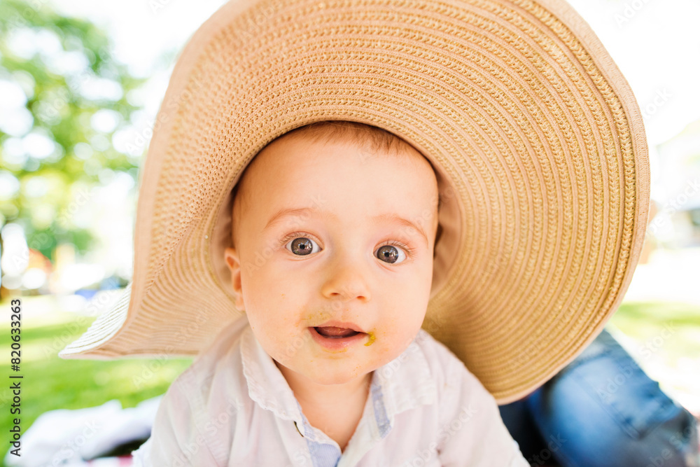 Baby with big hat crawling on picnic blanket, group picnic outdoor in park. Baby with big hat crawling on picnic blanket, group picnic outdoor in park.