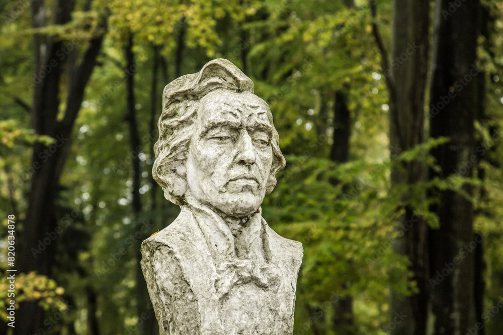 bust of Frederic Chopin against the background of leafy trees in a city park bust of Frederic Chopin against the background of leafy trees in a city park