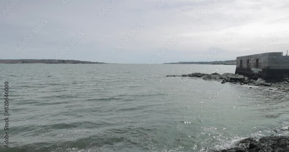 Old war time bunker and ocean lookout on the rocky shores of the Atlantic Ocean in Portland Maine during a overcast day in 4k. Old war time bunker and ocean lookout on the rocky shores of the Atlantic Ocean in Portland Maine during a overcast day in 4k.