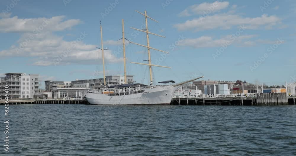Sailing on the Boston Harbour on a tourism ferry with a view of a sailing ship docked. Sailing on the Boston Harbour on a tourism ferry with a view of a sailing ship docked.