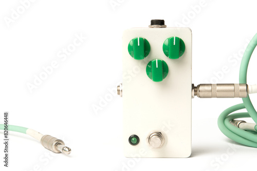 Blank guitar pedal with green knobs and jacks