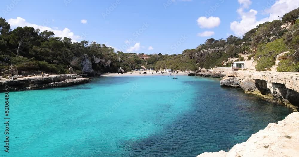 Tourists At Famous Cala Llombards Beach In Summer In Mallorca, Spain. wide shot Tourists At Famous Cala Llombards Beach In Summer In Mallorca, Spain. wide shot