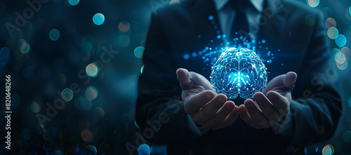 Businessman holding a brain hologram in his hands on a dark blue background with copy space