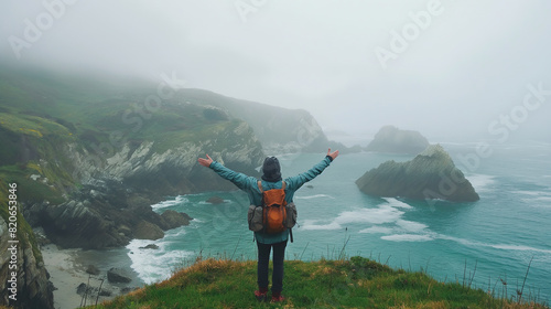 a hiker is standing in front of the coast 