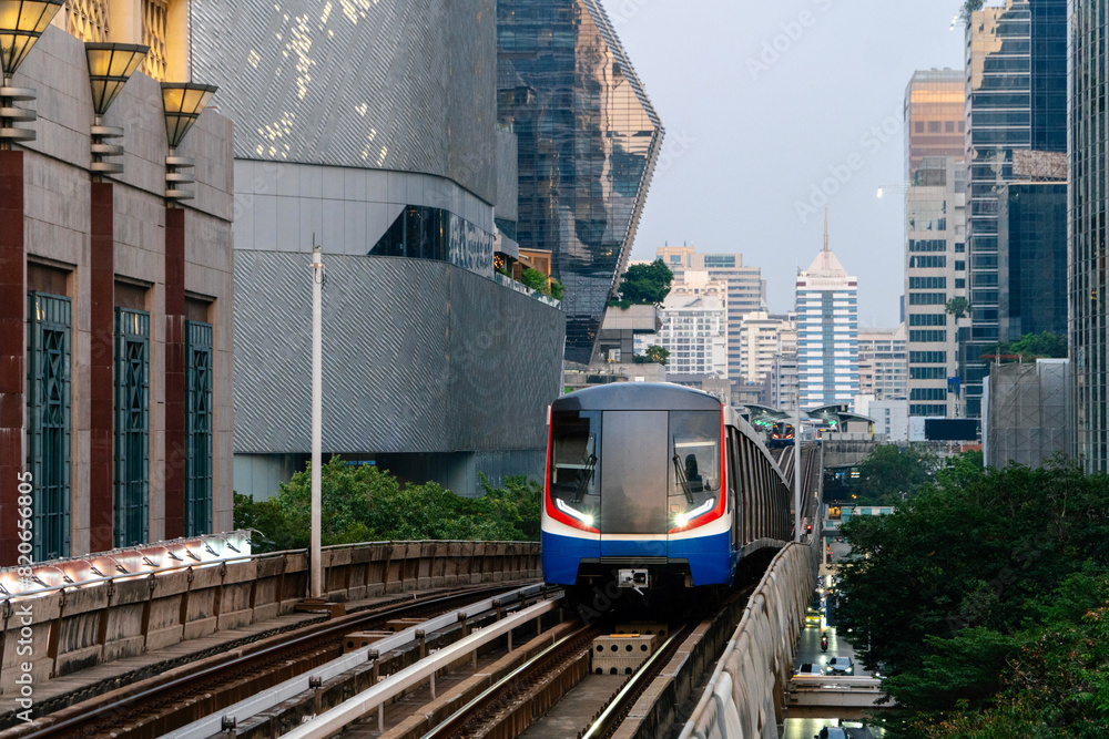 Naklejka premium BTS Skytrain, Electric train, running on the way with business office buildings on the background.