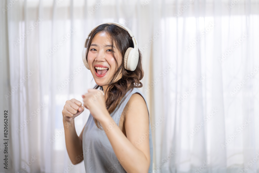 Portrait of smiling beauty asian woman happy and relax listening to music with headphones and singing, happy calm, resting ,good healthy, podcast, sound audio, listen online song at home Portrait of smiling beauty asian woman happy and relax listening to music with headphones and singing, happy calm, resting ,good healthy, podcast, sound audio, listen online song at home