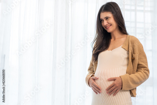 Happy smiling Mother woman hugging and smiling expecting with pregnancy hold baby in belly, woman pregnant, birth, preparation, maternity, care with childbirth at home.Love of family