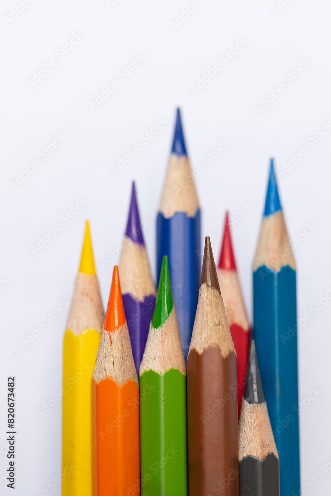 Vertical macro image of colored pencils The pointed tip is clearly visible isolated on a white background. Vertical macro image of colored pencils The pointed tip is clearly visible isolated on a white background.