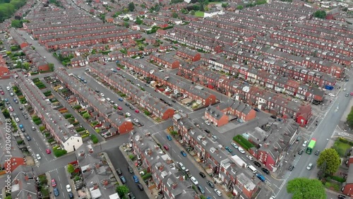 Aerial footage over looking the whole of Leeds from the Beeston area of the City Centre in West Yorkshire, the footage shows rows of 1940's terrace houses and playing fields in the summer time photo