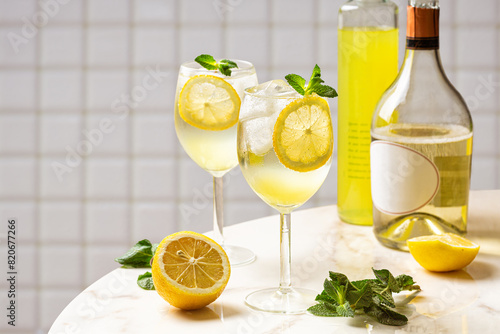 The Limoncello Spritz cocktail, delightful combination of limoncello, sparkling wine and soda with lemon, ice and mint. Italian summer drink. White background.
