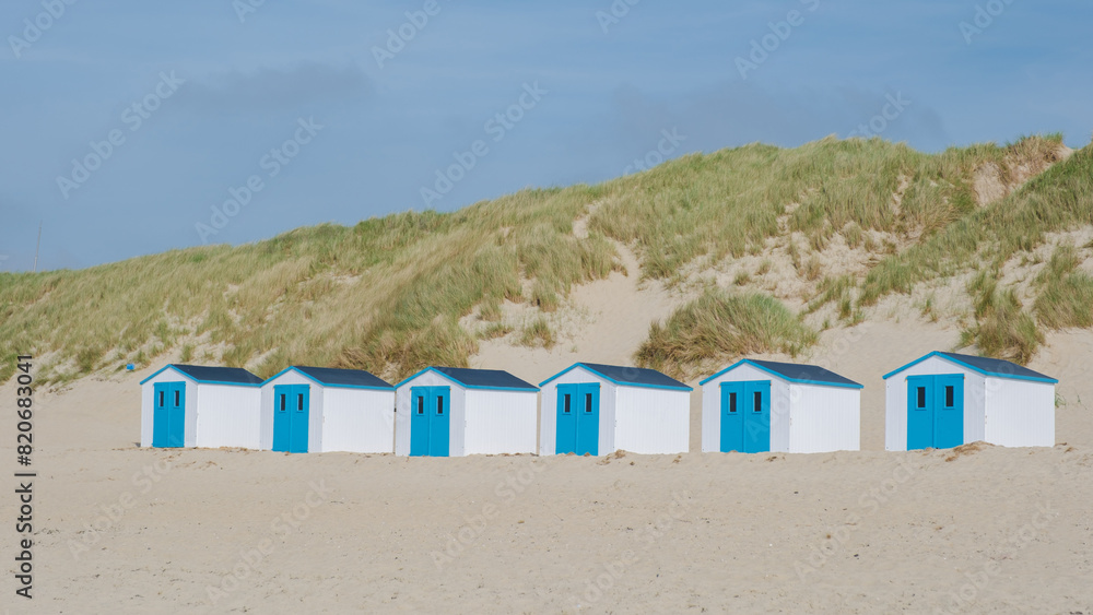A colorful row of beach huts standing proudly on a sandy beach in Texel, Netherlands, basking in the suns glow. De Koog beach Texel A colorful row of beach huts standing proudly on a sandy beach in Texel, Netherlands, basking in the suns glow. De Koog beach Texel