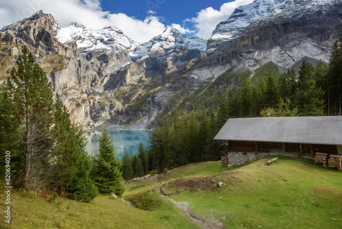Oeschinnensee, wooden chalet and Swiss Alps, Switzerland.