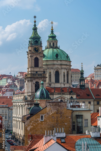 Church of St. Nicholas (built 1732-1737) against the backdrop of the roofs of the capital of the Czech Republic - the city of Prague
