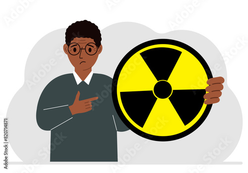 A man holds in his hand a large sign warning about radiation danger. Vector