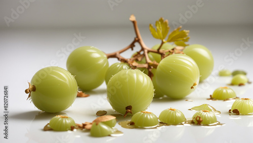 A small cluster of green gooseberries on white background photo