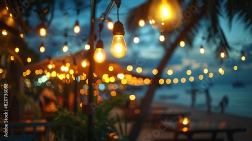 Atmosphere of a summer beach café is lit up by twinkling lights, with the soft light giving off a romantic and relaxing vibe. © MINHO