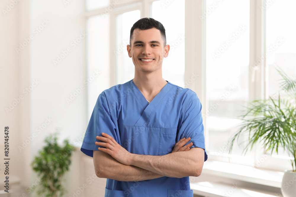 Portrait of smiling medical assistant with crossed arms in hospital Portrait of smiling medical assistant with crossed arms in hospital